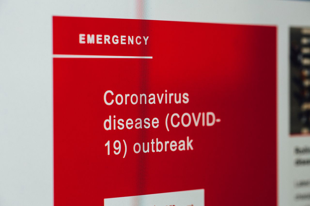 Close-up of a COVID-19 emergency alert message on a digital screen.
