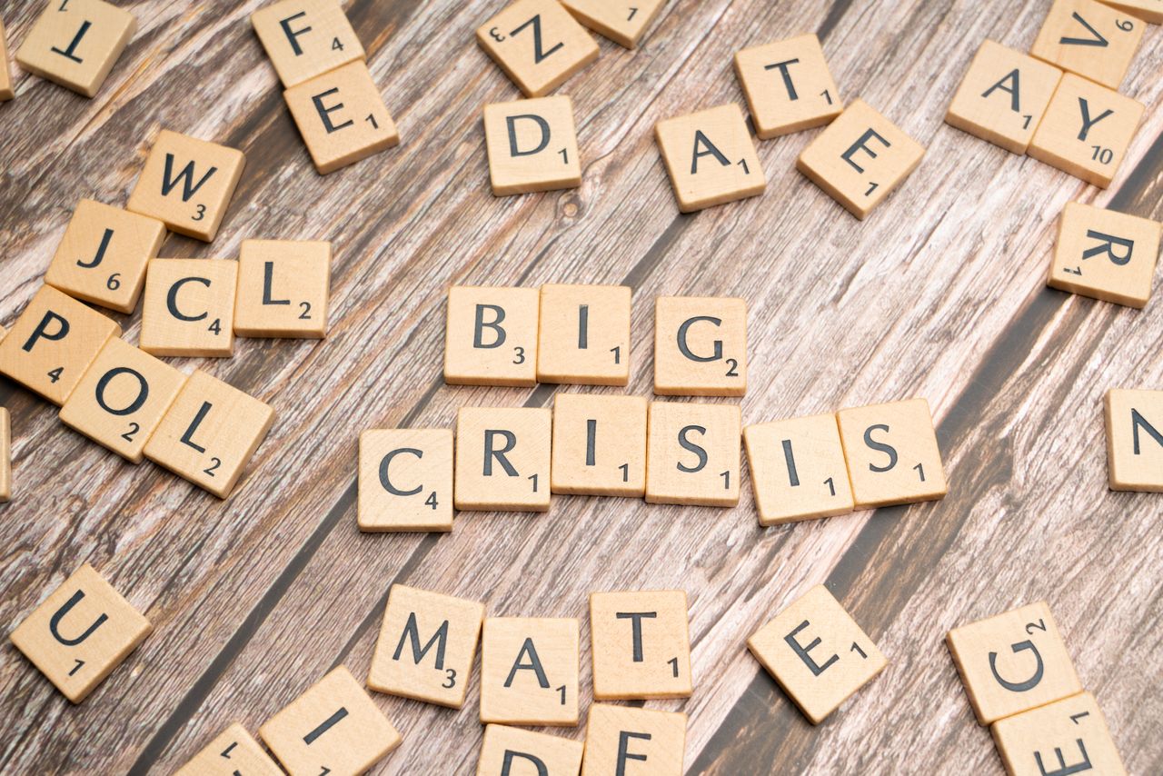 heros-img Wooden tiles forming the words Big Crisis on a wooden background.